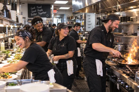 Line cooks in rhythm at the pass