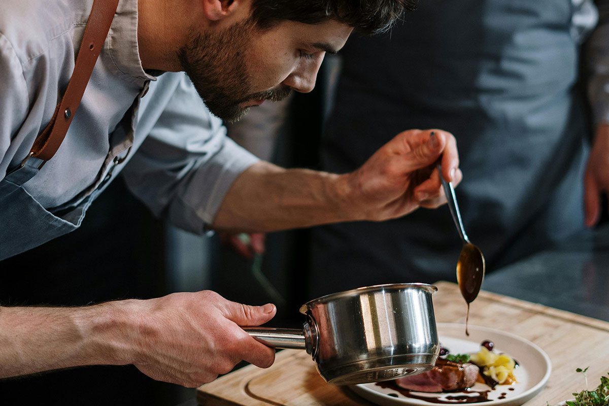 Chef is decorating food on a plate