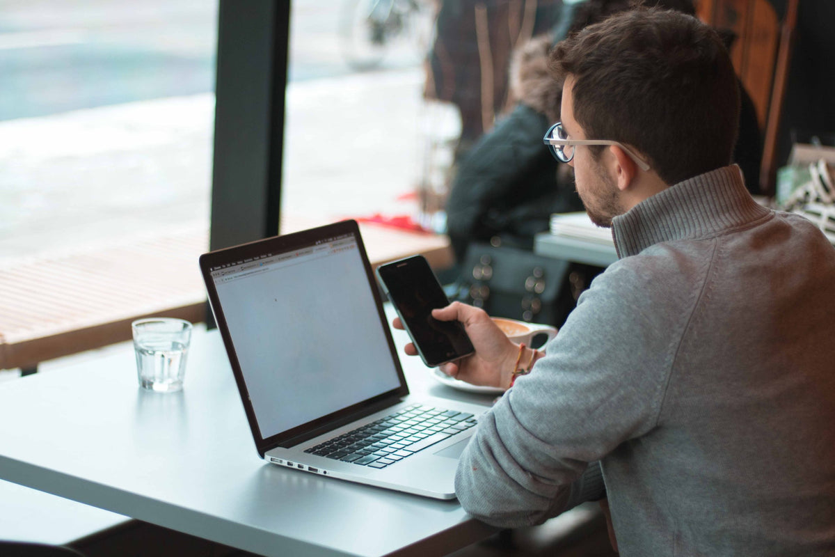 Man works on computer in restaurant.