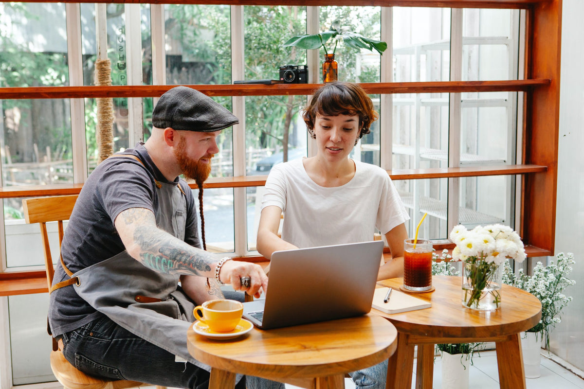 Restaurant workers meet with laptop.