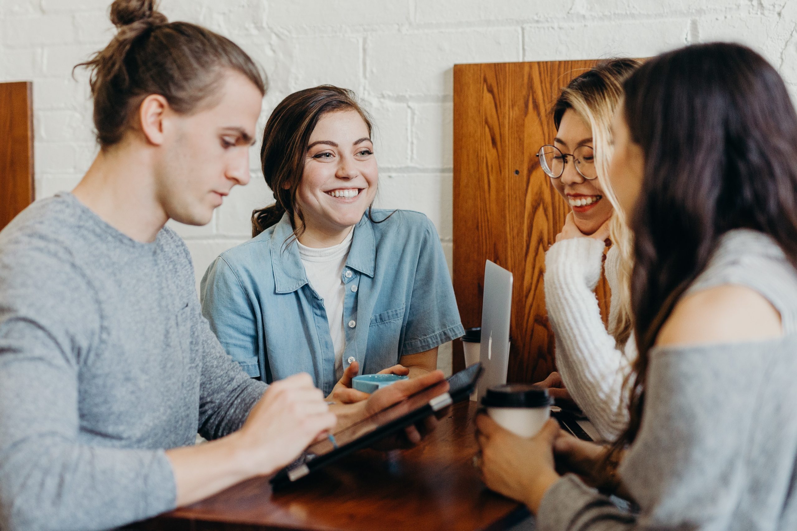 brooke-cagle–uHVRvDr7pg-unsplash (1) Employees meet over coffee.