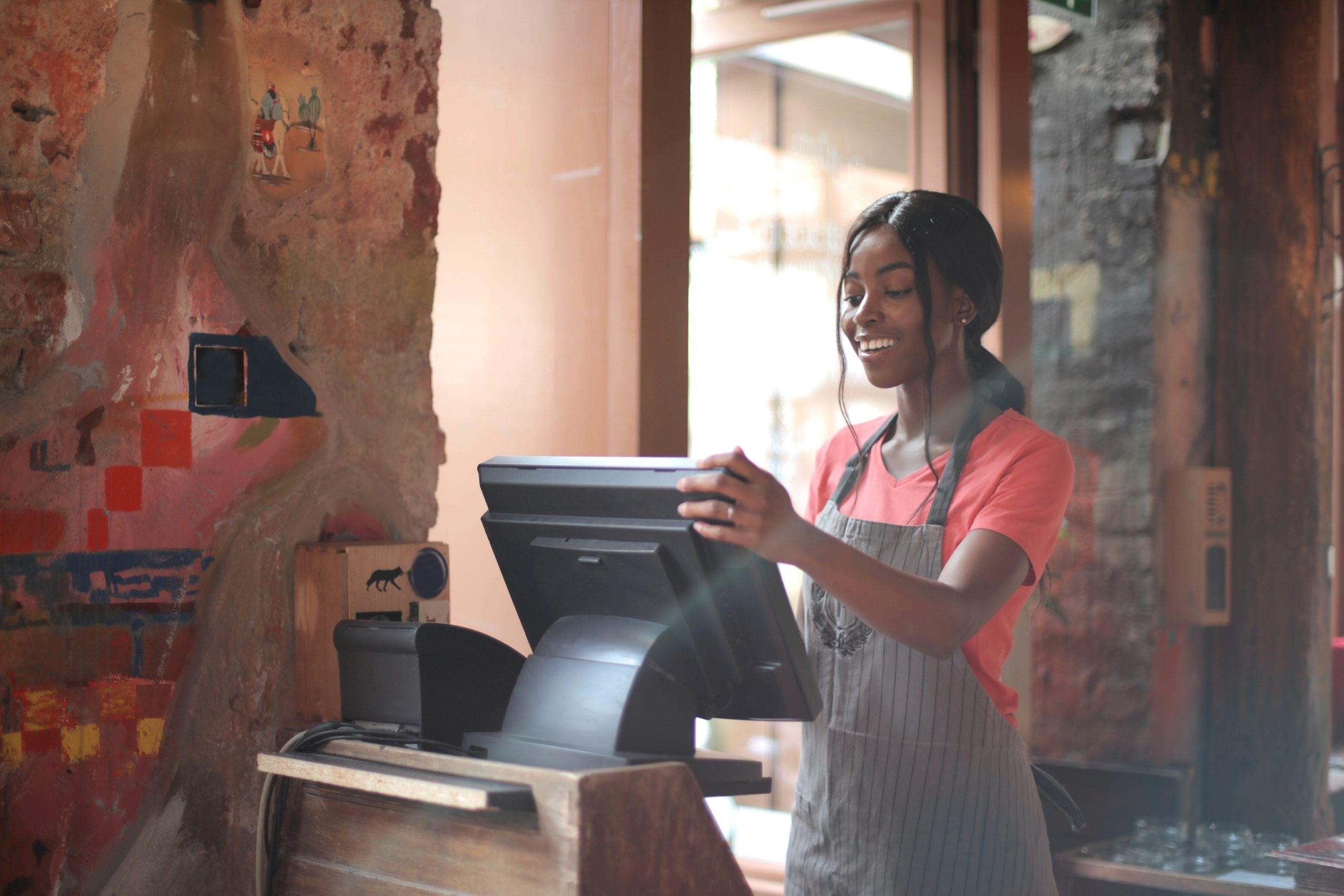 Young woman operates point-of-sale system in a restaurant.
