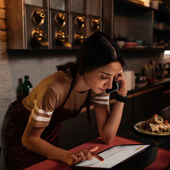 Front of house restaurant employee taking order in POS system